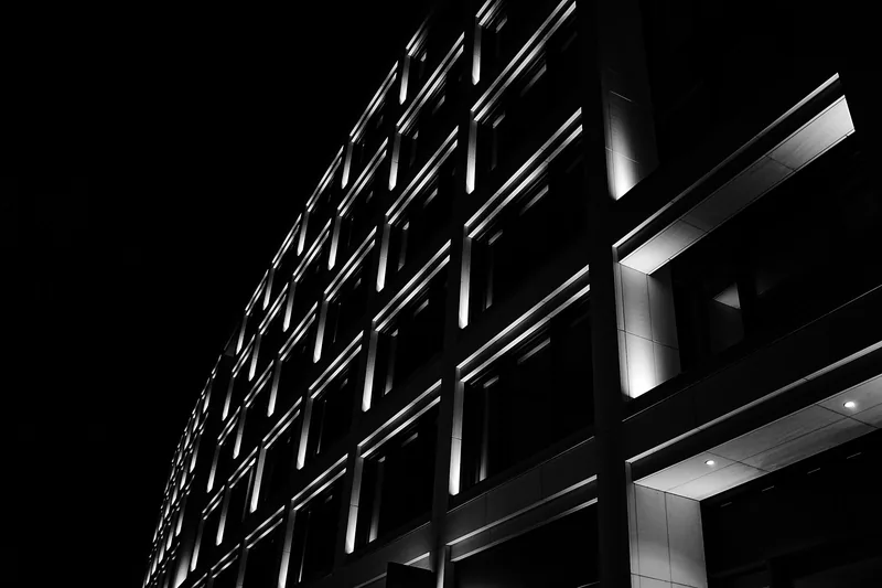 Placeholder photograph of an office building facade at night